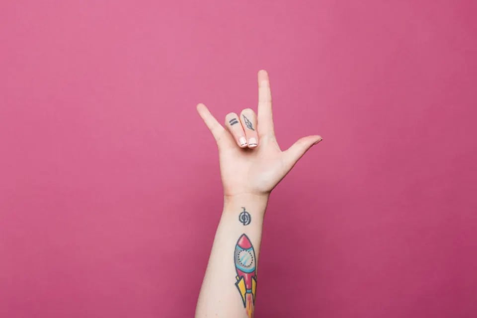Small colourful rocket tattoo on a wrist